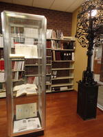 Display case at left, ornate ironwork post from old library at right