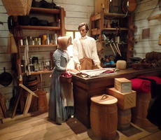 Lincoln in general store serving female customer