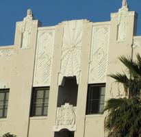 Art-deco style facade of building, with sphinxes on top