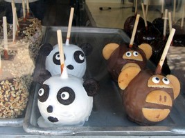 Caramel apples decorated as panda and monkey