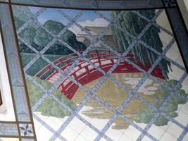 Tile mosaic of a red footbridge