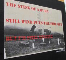 Mural w. poem “The sting of a burn / still wind puts the fire out / but I'm still melting”