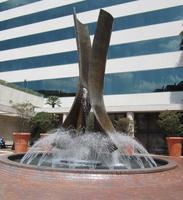 Fountain in shape of two curved vertical metal strips.