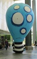 Huge blue inflated figurewith multiple eyes (a Tim Burton character)