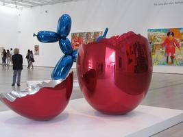 Immense red chromium “egg” broken in foreground, blue chromium “balloon dog” in background