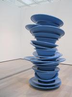 Stack of blue plastic dishes, many times life-size