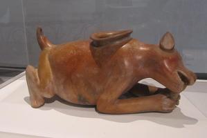 water vessel in shape of a dog gnawing a bone