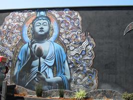 Mural of blue buddha holding a flower