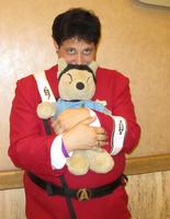 Man in starfleet uniform holding a Spock teddy bear