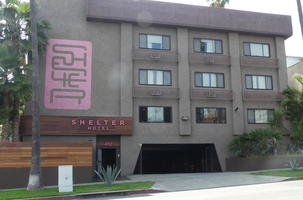 Exterior hotel w. pink logo at left.