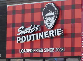Sign for Smoke's Poutinerie: Loaded Fries since 2008!