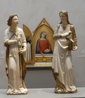 The Annunciation: Sculptures of Gabriel and the Virgin Mary, both dressed in white with gold trim