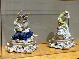 Small painted ceramic sculptures depicting mythological figures.