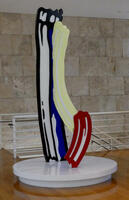 Tall vertical sculpture of red, yellow, and blue brush strokes