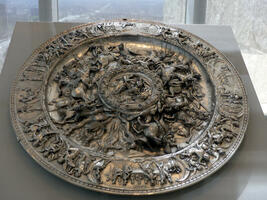Large shield-size silver plate with carvings of heroic figures
