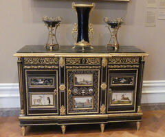 Cabinet with gold filigree and pictures of landscapes on doors
