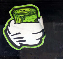 Sticker of a white gloved hand holding a roll of bills