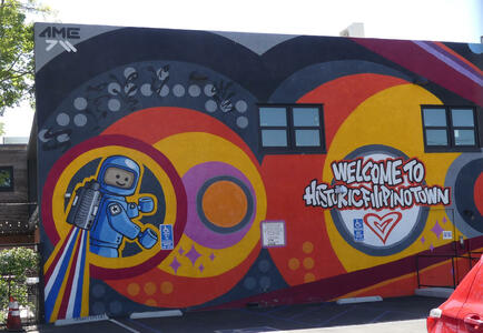 Wall art: Welcome to Historic Filipinotown (with person in spacesuit at left)
