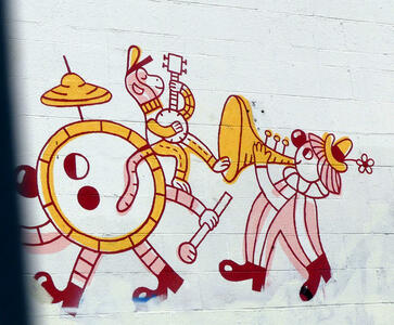 Whimsical drawing showing clown playing horn, monkey playing banjo, and walking drum and cymbal set