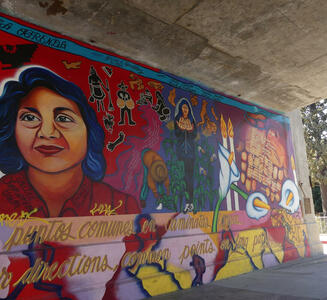 Continuation of mural, with farmworkers in middle and lilies on right