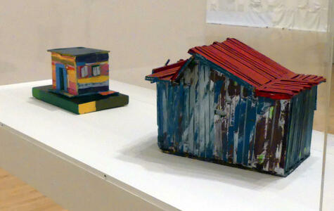 Small wooden houses, painted with multiple colors.
