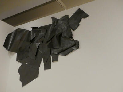Abstract black cloth artwork near ceiling