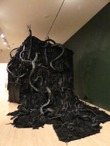 Large black structure with tree-root like extrusions