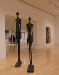 Tall thin sculptures of man and woman