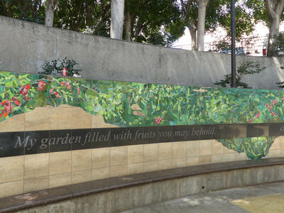Mosaic of vegetation and flowers. Text: “My garden filled with fruits you may behold”