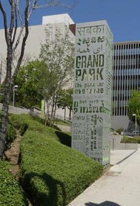 Metal rectangle at entrance to Grand Park, with words ”the park for everyone” stencil-cut into the metal in many languages