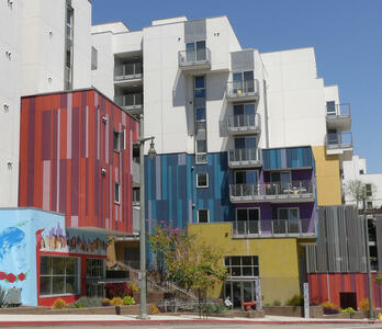 Buildings with vertical rectangular painted panels in multiple colors.