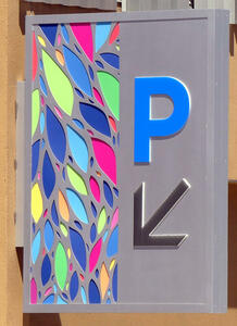 Parking sign with decorative multi-colored pastel leaf shapes