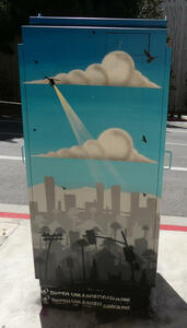 Painted utility box showing helicopter over a cityscape