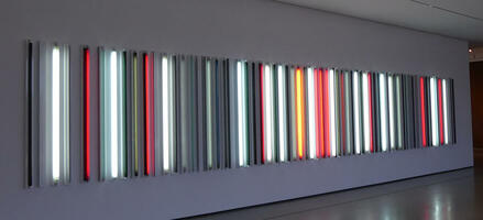 Row of vertically-oriented multi-colored fluorescent bulbs