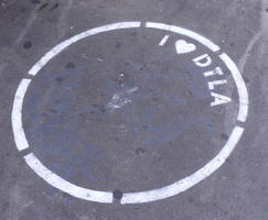 Spray-painted circle with stenciled text: I <heart> DTLA