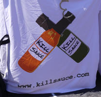 Green and red bottles labeled Kill Sauce