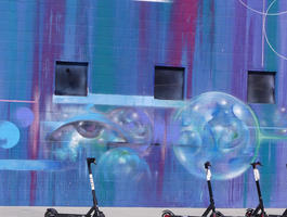 Wall art of soap bubbles with an eye in one, and abstract forms in others
