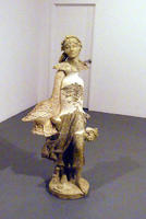 Sculpture of girl with arm in shape of a bird’s neck and bird’s tail as hand