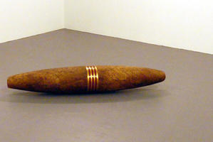 Large sculpture of a cigar with a gold and red band