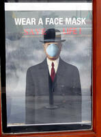 Man in bowler hat with face mask on; text says: WEAR A FACE MASK / SAVE A LIFE