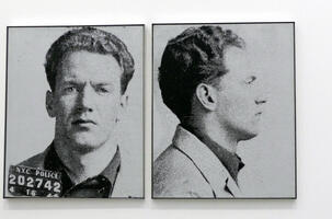 Large blow-up newspaper style photos of a most wanted criminal