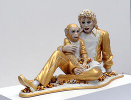 Sculpture of Michael Jackson and Bubbles the Chimp; both dressed in gold