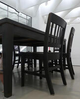 Black wooden table and chairs sized about 3 meters tall