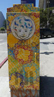 Utility box painted with face of child and background of geometric figures