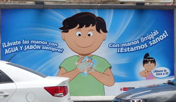 sign with cartoon image of boy washing hands.