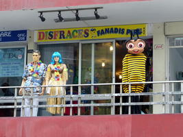 Disguise shop with two human mannequins and a bee costume.