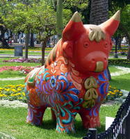 Side view of large ceramic bull, painted colorfully.