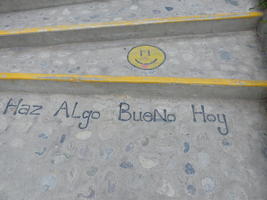 Smiley face and words “Do something good today” written on stairway