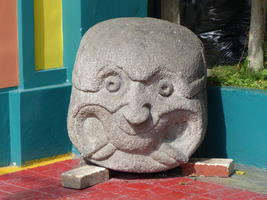smiling stone head outside shop