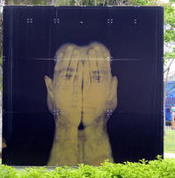 man with translucent hands in front of face